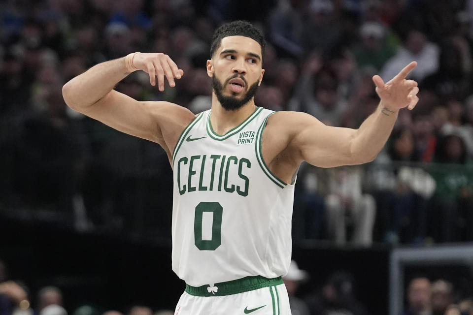 Boston Celtics forward Jayson Tatum reacts to scoring a three pointer during the second half of an NBA basketball game against the Dallas Mavericks in Dallas, Monday, Jan. 22, 2024. (AP Photo/LM Otero)