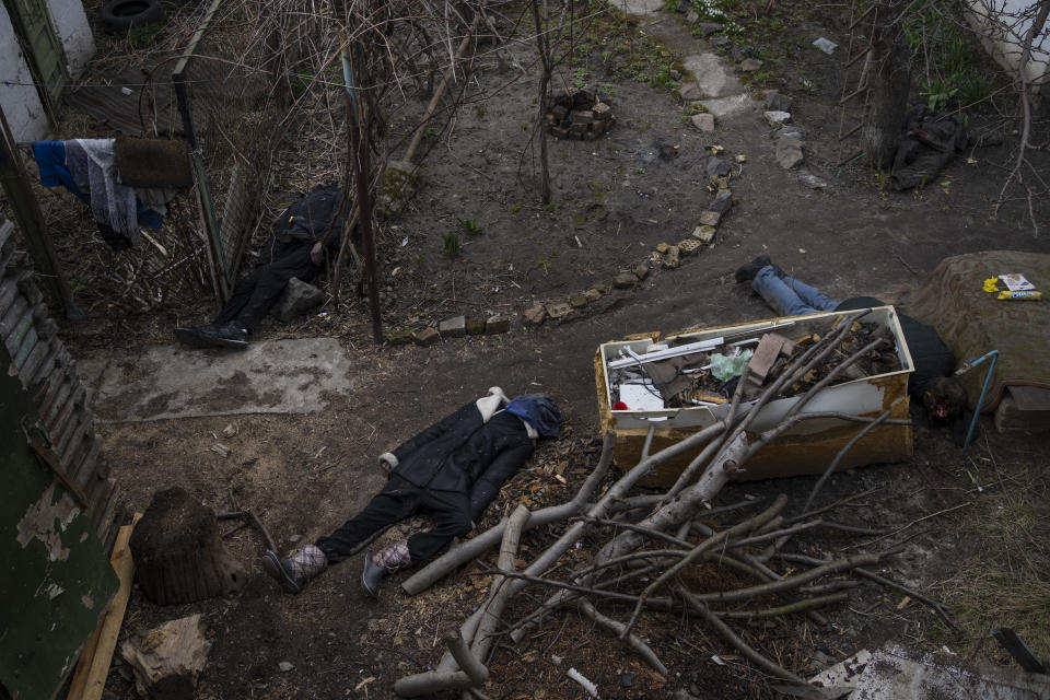 Three people lie on the ground after being killed in Bucha, on the outskirts of Kyiv, Ukraine, Monday, April 4, 2022. Russia is facing a fresh wave of condemnation after evidence emerged of what appeared to be deliberate killings of civilians in Ukraine. (AP Photo/Rodrigo Abd)