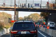 People celebrate the win of U.S. President-elect Joe Biden as the presidential motorcade transporting U.S. President Donald Trump drives back to the White House in Arlington