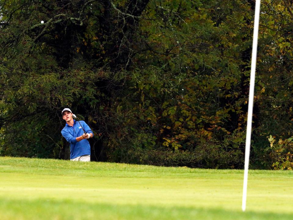 Madeira's Eddie Hartung chips on the 18th hole during the Division II state golf tournament on Saturday, Oct. 14, 2023, at NorthStar Golf Club in Sunbury, Ohio. Hartung shot 78 and finished 21st of 72 players.