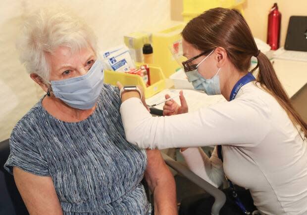 Bernice Brown, 82, of Halifax, receives her vaccine from Allison Milley, RN at the IWK Health Centre  on Feb. 22, 2021. Brown was the first senior in Nova Scotia to receive her vaccine in a community-based vaccination clinic.