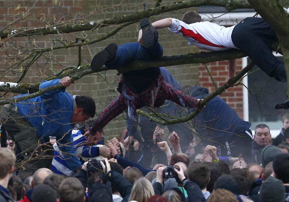 The game is played over Shrove Tuesday and Ash Wednesday. There are hundreds of players on each side - the Up'ards and Down'ards - determined by which side of the River Henmore they were born in (Reuters)