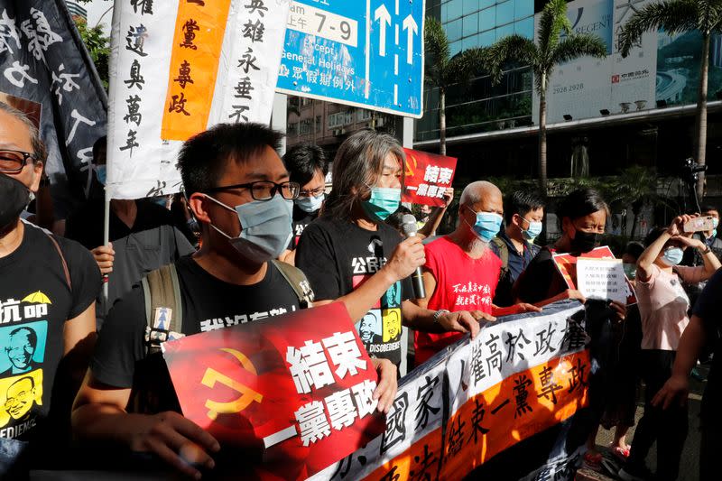 Pro-democracy protesters march during a demonstration near a flag raising ceremony on the anniversary of Hong Kong's handover to China in Hong Kong