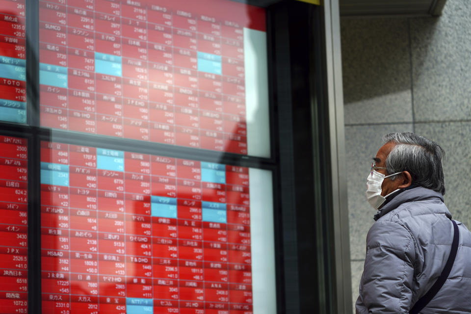 A man wearing a protective mask to help curb the spread of the coronavirus looks at an electronic stock board showing Japan's Nikkei 225 index at a securities firm Monday, Feb. 8, 2021, in Tokyo. Asian shares mostly rose Monday, tracking a rally on Wall Street last week, with Japan's benchmark momentarily reaching three-decade highs, on growing optimism about the global economy.(AP Photo/Eugene Hoshiko)