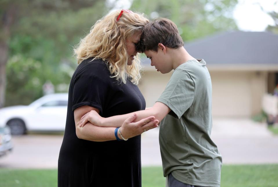 Emilie Campbell calmly talks to her son Connor Campbell, 16, as he pinches her arms near their home in Provo on Sunday, May 28, 2023. Connor is autistic, nonverbal and has epilepsy. He lives at the Utah State Developmental Center in American Fork but comes home on Sundays. | Kristin Murphy, Deseret News