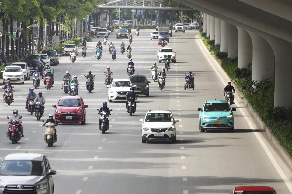 This photo shows Vinfast electric cars in traffic in Hanoi, Vietnam on June 10, 2024. Vietnamese automaker VinFast just can’t sell enough cars, so it's hoping its tiniest and cheapest car yet — a roughly 10-foot-long mini-SUV priced at $9,200 and called the VF3 — will become Vietnam's “national car" and win over consumers in Asian markets. (AP Photo/Hau Dinh)