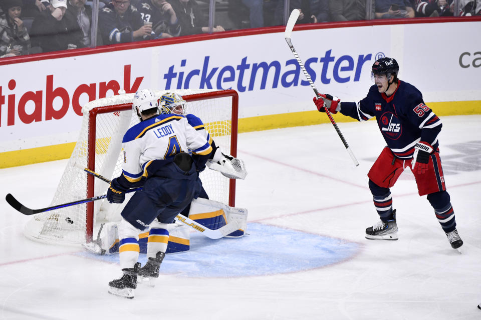 Winnipeg Jets' Mark Scheifele (55) celebrates a goal on St. Louis Blues goaltender Jordan Binnington (50) during the third period of an NHL hockey game Tuesday, Oct. 24. 2023, in Winnipeg, Manitoba. (Fred Greenslade/The Canadian Press via AP)