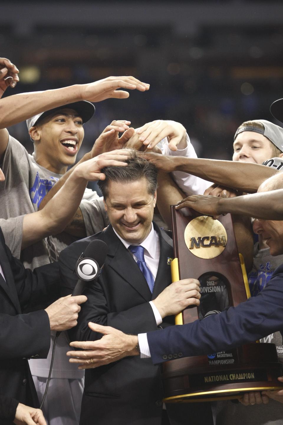 Kentucky players mess up coach John Calipari's hair while he accepts the National Championship trophy. Apr. 2, 2012