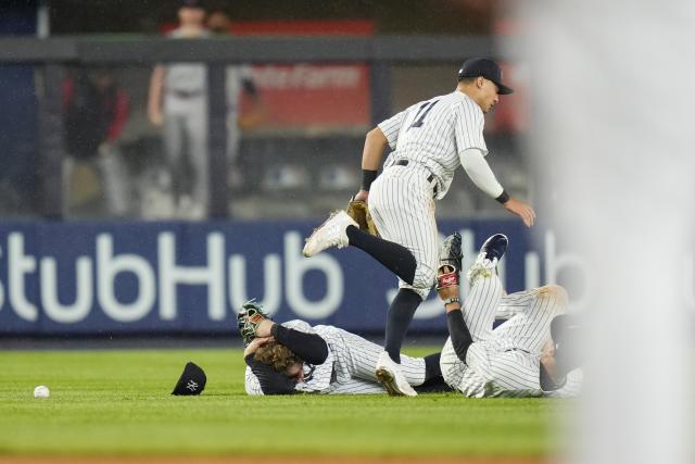 A trainer helps New York Yankees' Oswald Peraza off the field after he was  hurt during the ninth inning of a baseball game against the Cleveland  Guardians, Wednesday, May 3, 2023, in