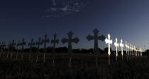 <p>The sun is reflected on some of the 26 crosses placed in a field before a vigil for the victims of the First Baptist Church shooting Monday, Nov. 6, 2017, in Sutherland Springs, Texas. (Photo: David J. Phillip/AP) </p>