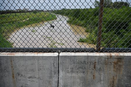 Markings from hopeful asylum seekers are pictured above the Rio Grande on the Mexican side of the Brownsville-Matamoros International Bridge