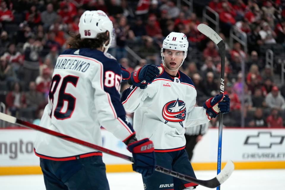 Columbus Blue Jackets center Adam Fantilli (11) celebrates his goal with Kirill Marchenko (86) against the Detroit Red Wings in the first period of an NHL hockey game Saturday, Nov. 11, 2023, in Detroit. (AP Photo/Paul Sancya)