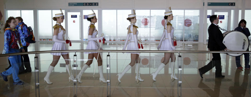 Cheerleaders arrive for the women's 500-meter speedskating race at the Adler Arena Skating Center at the 2014 Winter Olympics, Tuesday, Feb. 11, 2014, in Sochi, Russia.