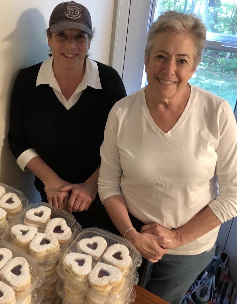 Traci Anello, left, and Debbie Hall, of The Community Gourmet, are seen here on Friday, Sept. 2, with the cookies they recently made to help them raise funds for the meal kits they assemble to help the hungry. Their organization is a recipient of the Daily Points of Light Award, a recognition started by President George H. W. Bush.