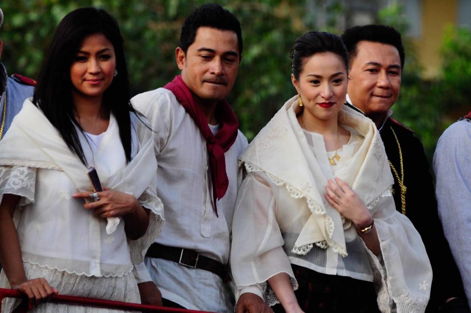 The casts of the MMFF 2012 entry "El Presidente" are seen as their float makes its way through the crowd at the 2012 Metro Manila Film Festival Parade of Stars on 23 December 2012. (L-R) Alicia Mayer, Cesar Montano, Cristine Reyes, Governor E.R. Ejercito, Christopher de Leon and Bayani Agbayani. (Angela Galia/NPPA Images)