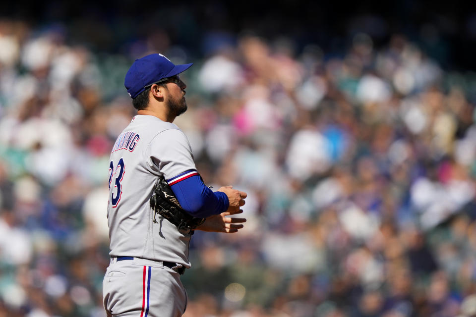 Texas Rangers starting pitcher Dane Dunning looks to the outfield between batters during the third inning of a baseball game against the Seattle Mariners, Sunday, Oct. 1, 2023, in Seattle. (AP Photo/Lindsey Wasson)