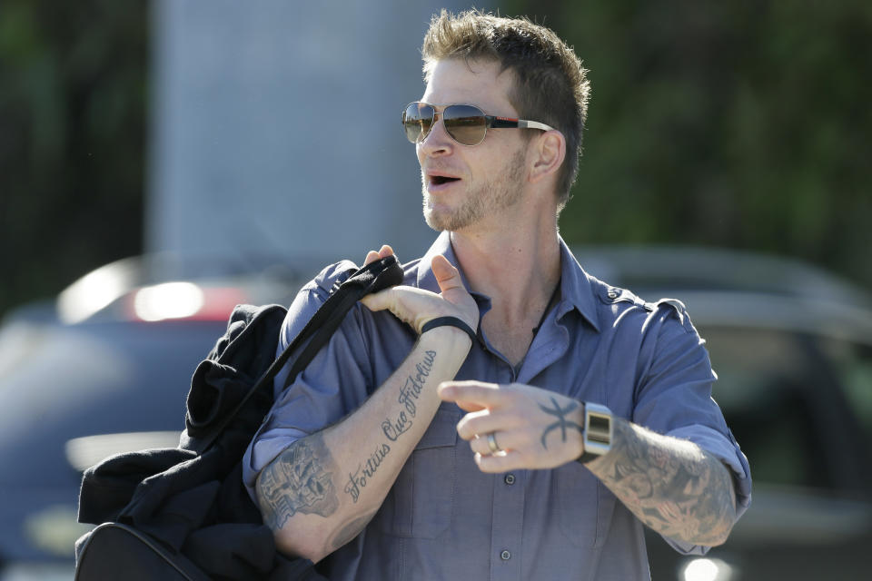 Philadelphia Phillies pitcher A.J. Burnett arrives at Bright House Field before a spring training baseball practice Sunday, Feb. 16, 2014, in Clearwater, Fla. (AP Photo/Charlie Neibergall)