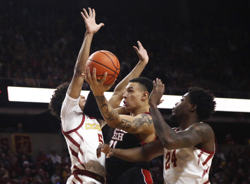 Texas Tech forward KyeRon Lindsay drives to the basket as Iowa State's Curtis Jones (5) and Hason Ward (24) defend in the first half of an NCAA college basketball game, Saturday, Feb. 17, 2024, in Ames, Iowa. (AP Photo/Bryon Houlgrave)