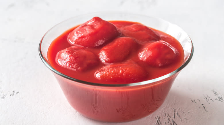 Whole canned tomatoes in bowl 