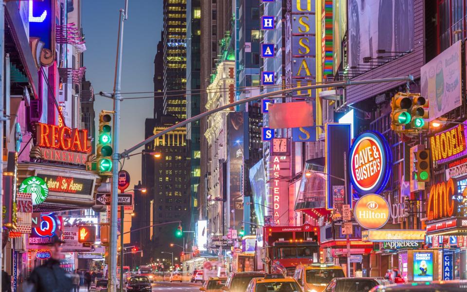 The neon signs of 42nd Street in New York