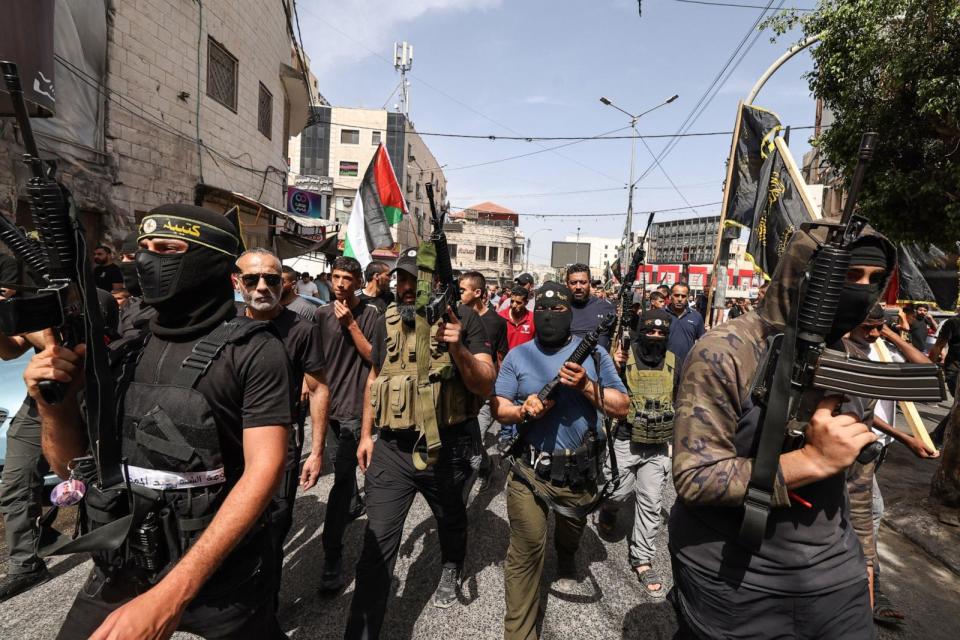 PHOTO: Armed Palestinian militants attend a group funeral of people killed in a raid by Israeli forces, in Jenin, in the occupied West Bank on May 23, 2024.  (Zain Jaafar/AFP via Getty Images)