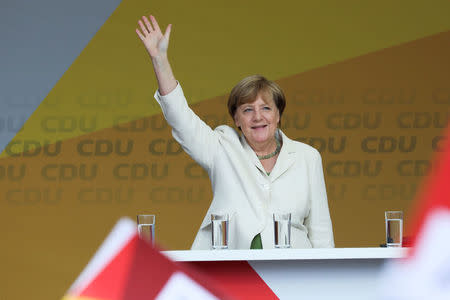 German Chancellor Angela Merkel a top candidate for or the upcoming general elections of the Christian Democratic Union party (CDU) waves to supporters during an election campaign rally in Quedlinburg, Germany, August 26, 2017. REUTERS/Reinhard Krause