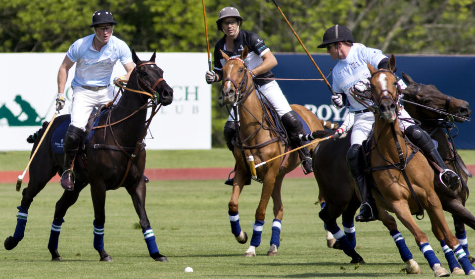 Britain's Prince Harry, left, rides during the Sentebale Royal Salute Polo Cup charity match in Greenwich, Conn., Wednesday, May 15, 2013. (AP Photo/Craig Ruttle)