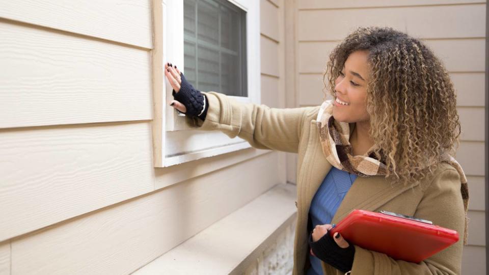 woman gets a home inspector after reading What Not to Fix When Selling a House