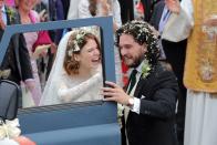 <p><em>Games of Thrones </em>costars, Rose Leslie and Kit Harington, smile as guests throw flower petals at them after their ceremony in Aberdeen, Scotland in 2018.  </p>