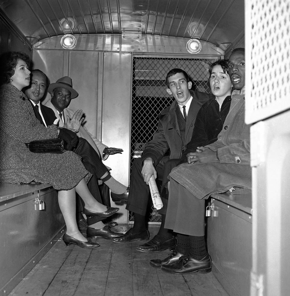 Six demonstrators, led by the Rev. Logan Kearse, third from left, sit in a police paddy wagon on their way to jail after their arrest Nov. 11, 1961, at Hooper's Restaurant in Baltimore.