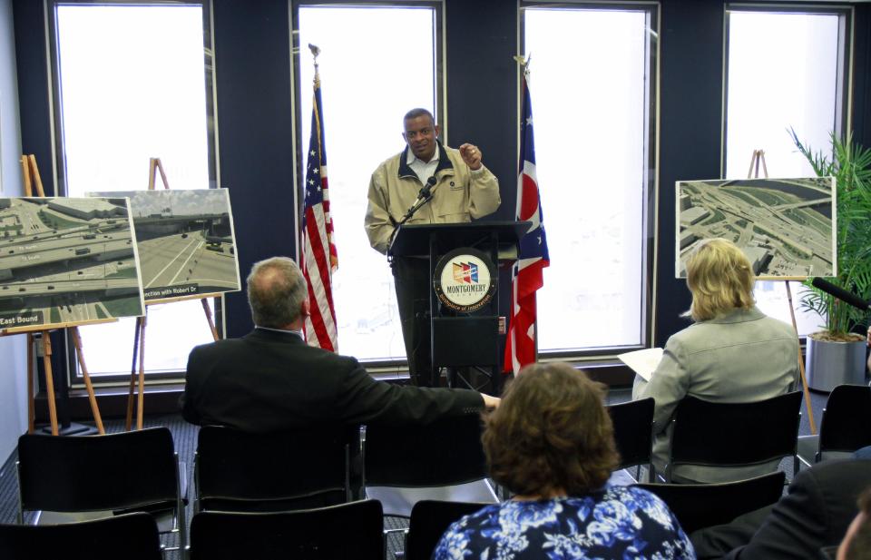 This photo taken April 14, 2014 shows Transportation Secretary Anthony Foxx speaking to the media and local government officials about federal transportation funding at the Montgomery County Commissioner's office in Dayton, Ohio. On the road in a tour bus this week, Foxx is urging Congress to quickly approve legislation to pay for highway and transit programs amid warnings that the U.S. government’s Highway Trust Fund is nearly broke. If allowed to run dry, that could threaten to set back or shut down projects across the country, force widespread layoffs of construction workers and delay needed repairs and improvements. (AP Photo/Skip Peterson)