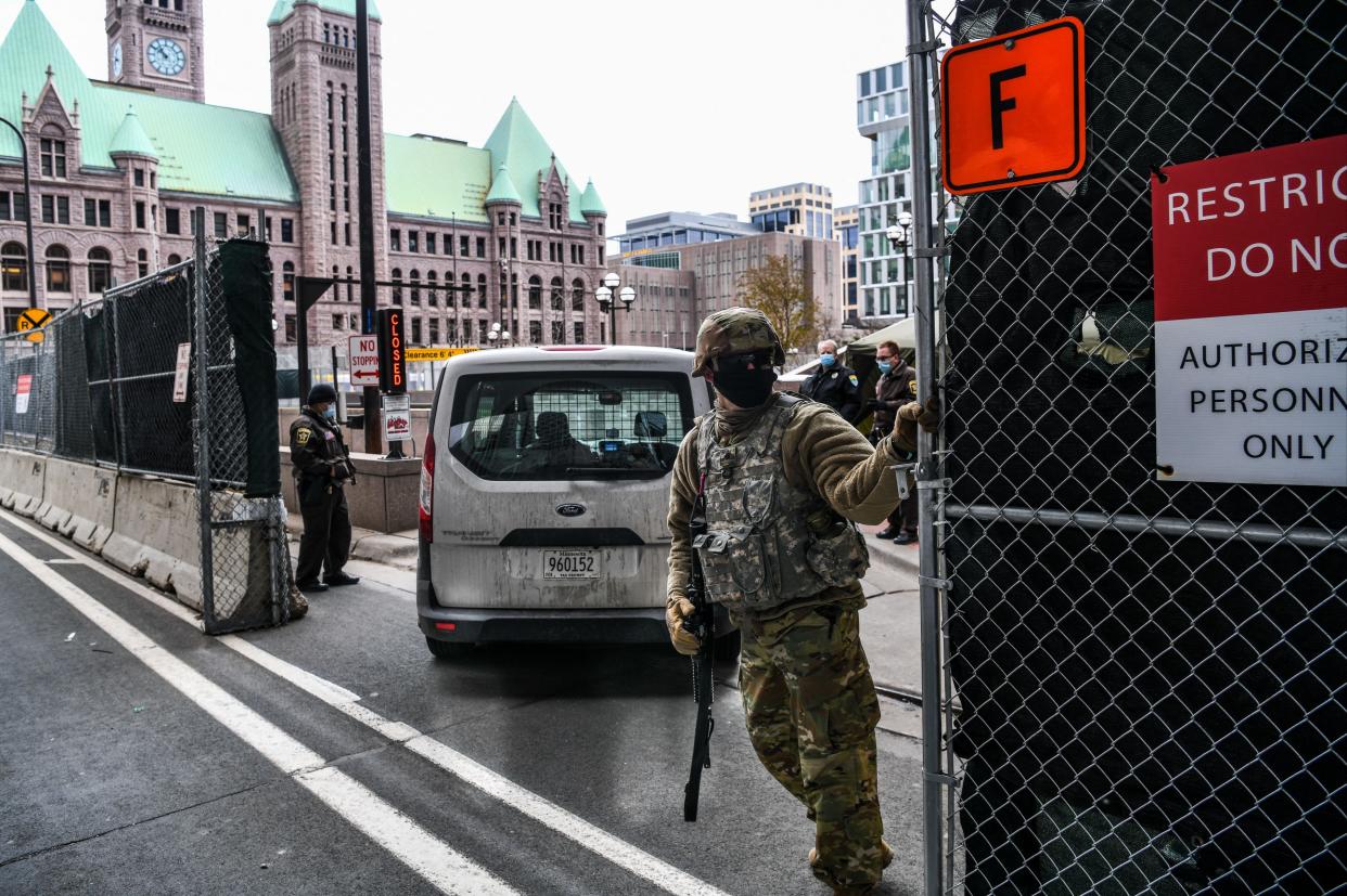 National Guards and other Law enforcement officers stand guard outside the Hennepin County Government Centre in Minneapolis (AFP via Getty Images)