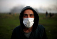 <p>A protester wearing a medical mask poses for a photograph at the scene of clashes with Israeli troops near the border with Israel, east of Gaza City, Jan. 12, 2018. “The world must understand that unemployment is driving us all towards becoming fighters. We are not going to fight Hamas or Fatah, we will fight the Jews only. We have taken part in rallies demanding Hamas and Fatah end their division and calling for more electricity but we are not going to the streets to throw stones at Hamas or at the Palestinian Authority,” he said. (Photo: Mohammed Salem/Reuters) </p>