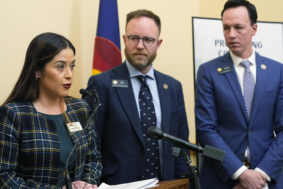 From left, Patty Salazar, executive director of the Colorado Department of Regulatory Agencies makes a point as Colorado State Rep. Matt Soper, R-Delta, and Colorado Sen. Dylan Roberts, D-Eagle, listen during a news conference to unveil bipartisan legislation to license funeral home professionals in Colorado Monday, March 4, 2024, the State Capitol in Denver. (AP Photo/David Zalubowski)