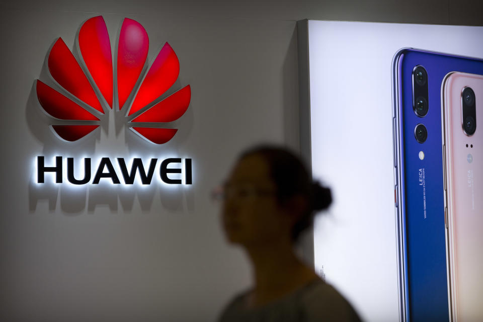 FILE - In this July 4, 2018, file photo, a shopper walks past a Huawei store at a shopping mall in Beijing. Canadian authorities said Wednesday, Dec. 5, 2018, that they have arrested the chief financial officer of China's Huawei Technologies for possible extradition to the United States. (AP Photo/Mark Schiefelbein, File)