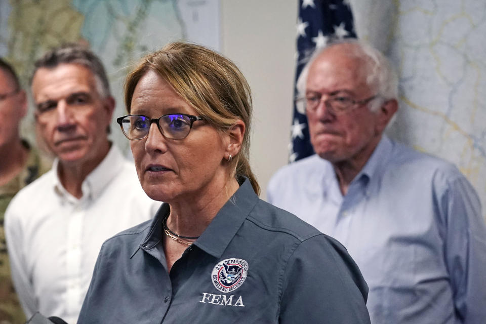 FEMA Administrator Deanne Criswell, center, addresses reporters flanked by Vermont Gov. Phil Scott, left, and U.S. Sen. Bernie Sanders, I-VT, Wednesday, July 12, 2023, in Berlin, Vt. Following a storm that dumped nearly two months of rain in two days, Vermonters are cleaning up from the deluge of water. (AP Photo/Charles Krupa)