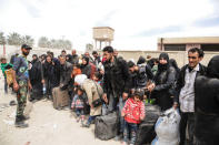 People are seen evacuated by Syrian forces from eastern Ghouta in Saqba, Syria, March 18, 2018. SANA/Handout via REUTERS ATTENTION EDITORS - THIS IMAGE HAS BEEN SUPPLIED BY A THIRD PARTY. REUTERS IS UNABLE TO INDEPENDENTLY VERIFY THIS IMAGE.