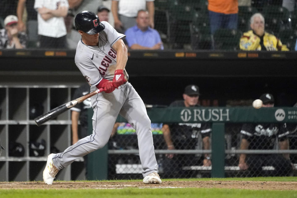 Cleveland Guardians' Myles Straw swings for a two-run double during the 11th inning of the team's baseball game against the Chicago White Sox on Tuesday, Sept. 20, 2022, in Chicago. The Guardians won 10-7. (AP Photo/Charles Rex Arbogast)