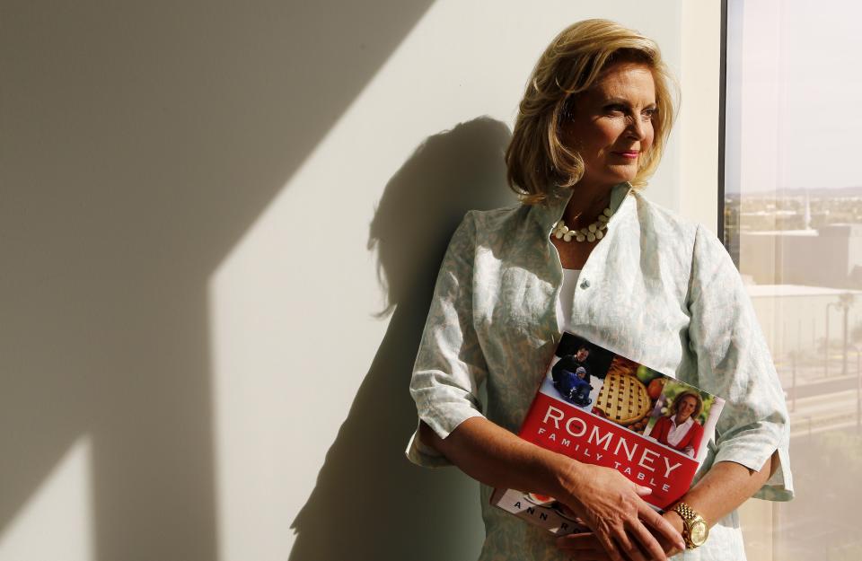 In this Monday, Oct. 7, 2013 photo, Ann Romney, poses with her bestselling cookbook, “The Romney Family Table: Sharing Home-Cooked Recipes & Favorite Traditions” in Phoenix. (AP Photo/Ross D. Franklin)