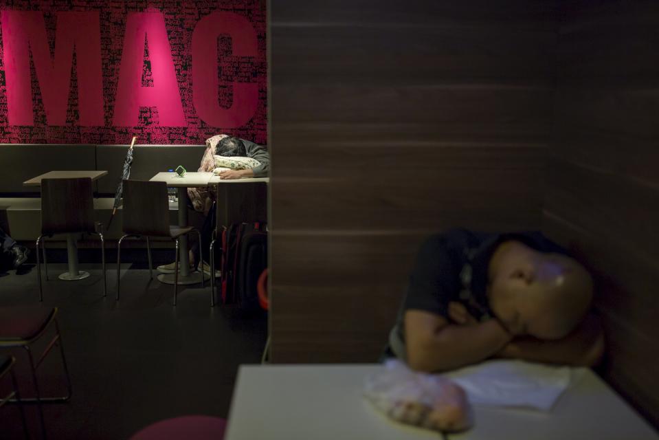 Men sleep at 24-hour McDonald's in Hong Kong, China