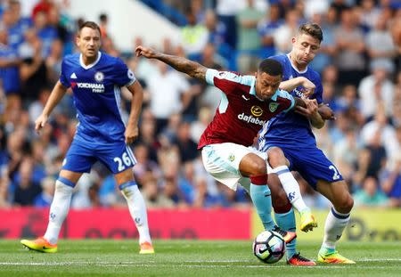 Football Soccer Britain - Chelsea v Burnley - Premier League - Stamford Bridge - 27/8/16 Burnley's Andre Gray in action with Chelsea's Gary Cahill as John Terry looks on Reuters / Eddie Keogh Livepic