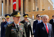 Turkey's Prime Minister Binali Yildirim (R), flanked by Chief of Staff General Hulusi Akar (L) and the country's top generals, leaves Anitkabir, the mausoleum of modern Turkey founder Mustafa Kemal Ataturk, after a wreath-laying ceremony ahead of a High Military Council meeting in Ankara, Turkey, July 28, 2016. REUTERS/Umit Bektas