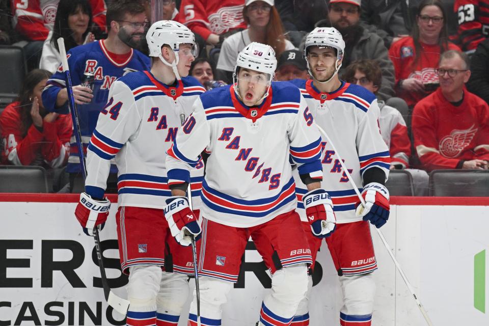 Apr 5, 2024; Detroit, Michigan, USA; New York Rangers left wing Will Cuylle (50) celebrates his with right wing Kaapo Kakko (24) and center Alex Wennberg (91) during the first period against the Detroit Red Wings at Little Caesars Arena.