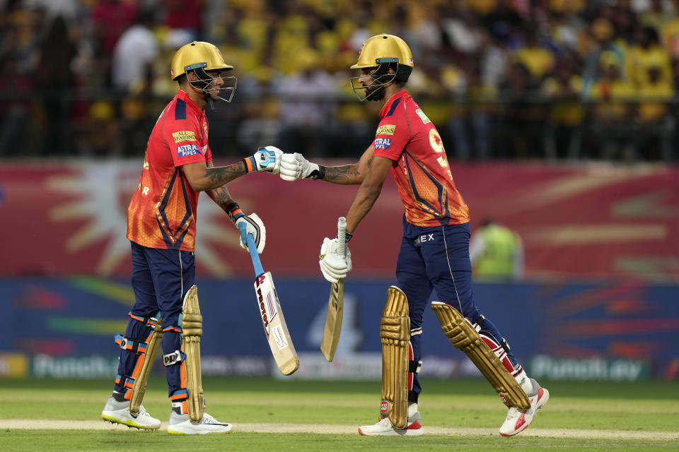 Punjab Kings' Harpreet Brar, right, and teammate Rahul Chahar touch gloves as they bat during the Indian Premier League cricket match between Chennai Super Kings and Punjab Kings in Dharamshala, India, Sunday, May 5, 2024. (AP Photo /Ashwini Bhatia)