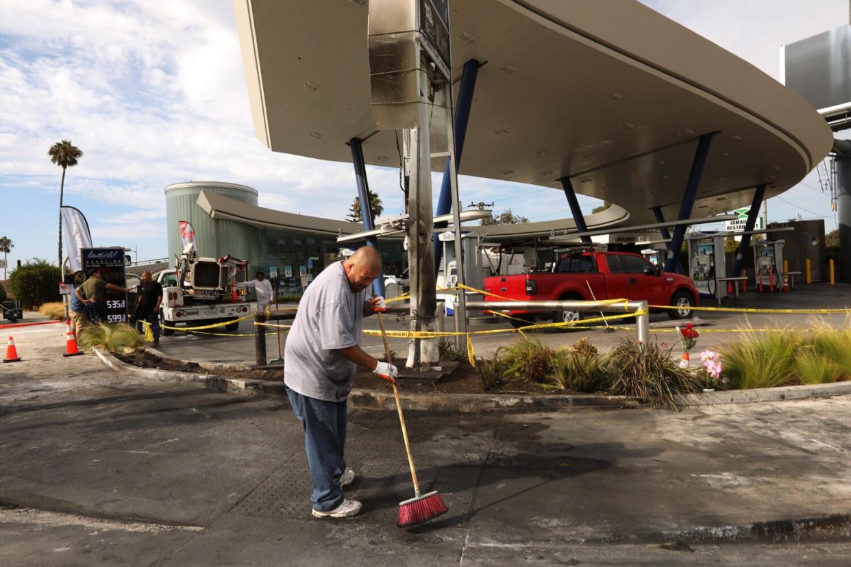 A man sweeps with a broom.