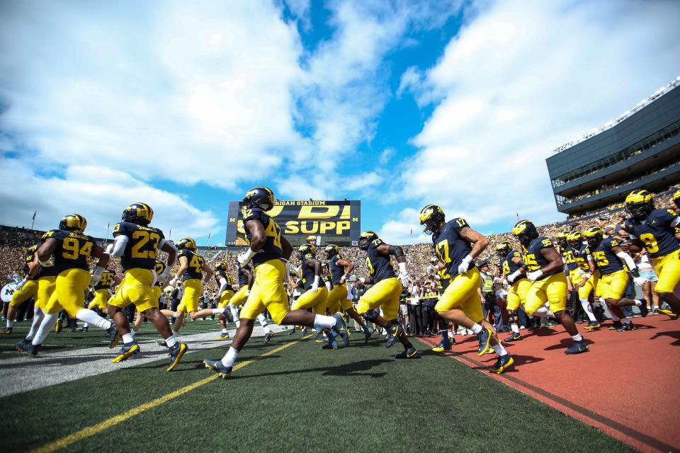 Michigan players take the field for the UNLV game at Michigan Stadium in Ann Arbor on Saturday, Sept. 9, 2023.