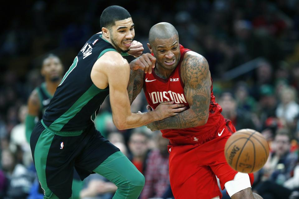 Boston Celtics' Jayson Tatum, left, and Houston Rockets' PJ Tucker battle for a loose ball during the second half of an NBA basketball game in Boston, Sunday, March 3, 2019. (AP Photo/Michael Dwyer)