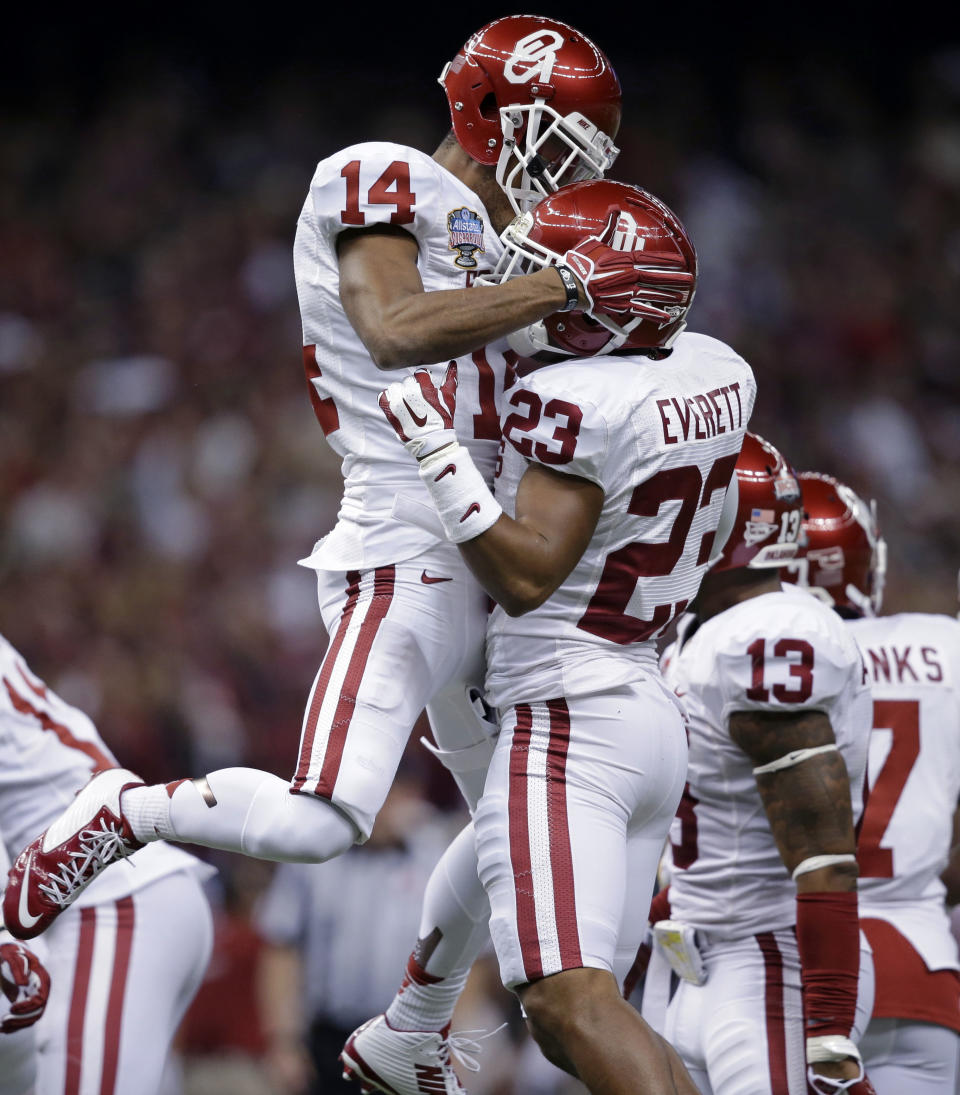 Oklahoma defensive backs Kass Everett (23) and Aaron Colvin (14) celebrate a defensive stop during the first half of the Sugar Bowl NCAA college football game against Alabama, Thursday, Jan. 2, 2014, in New Orleans.(AP Photo/Patrick Semansky)