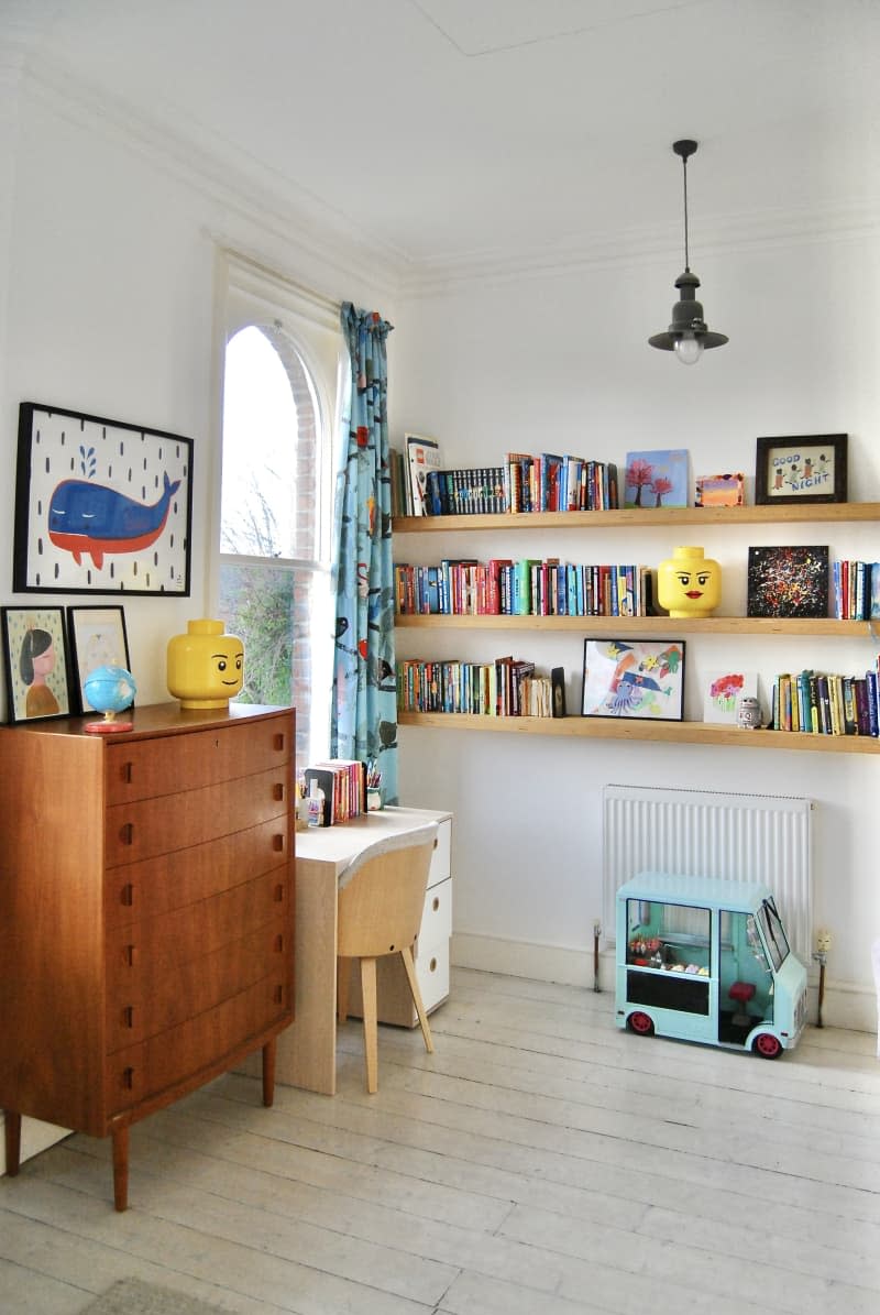 A child's desk with three shelves and a modern dresser.