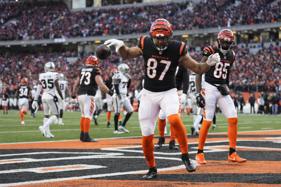 Cincinnati Bengals' C.J. Uzomah (87) celebrates a touchdown catch during the first half of an NFL wild-card playoff football game against the Las Vegas Raiders, Saturday, Jan. 15, 2022, in Cincinnati. (AP Photo/AJ Mast)